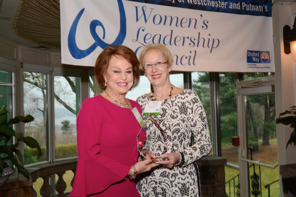 Elizabeth Bracken Thompson, partner Thompson & Bender, accepts Women of Distinction Award from BCW President and CEO Marsha Gordon.